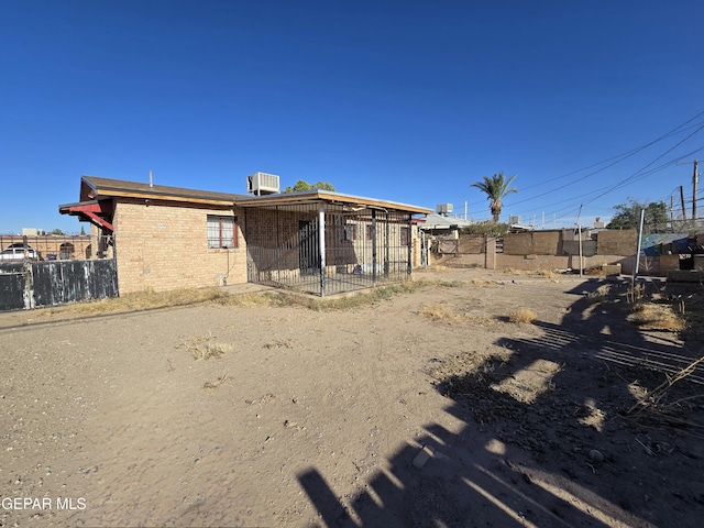 371 Medina St, El Paso, TX 79905 - back of property featuring brick siding and central AC