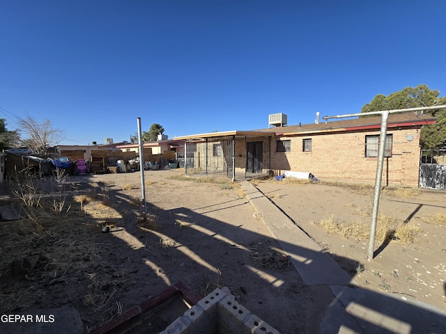 371 Medina St, El Paso, TX 79905 - rear view of house with brick siding and cooling unit