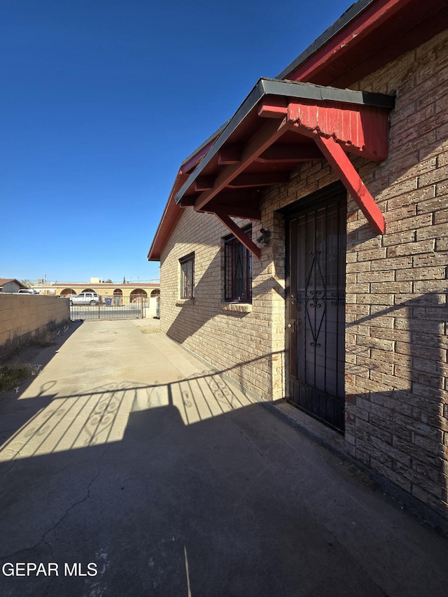 371 Medina St, El Paso, TX 79905 - view of exterior entry featuring concrete driveway and brick siding