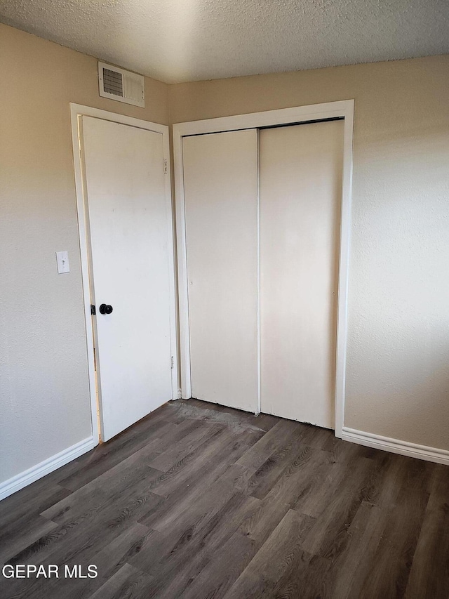 338 Maricela Dr, El Paso, TX 79915 - unfurnished bedroom featuring wood finished floors, a closet, and baseboards