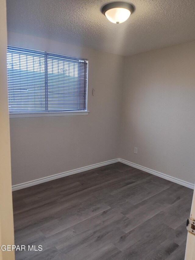 338 Maricela Dr, El Paso, TX 79915 - unfurnished room with a textured ceiling, dark wood-style flooring, and baseboards