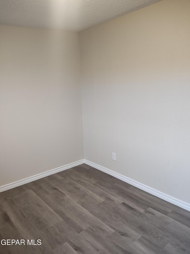 338 Maricela Dr, El Paso, TX 79915 - spare room featuring dark wood finished floors and baseboards