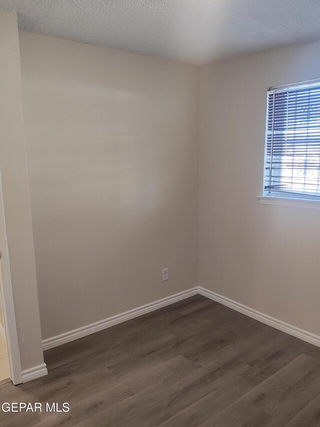 338 Maricela Dr, El Paso, TX 79915 - unfurnished room with dark wood-style floors and baseboards
