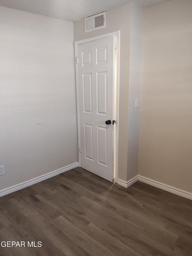 338 Maricela Dr, El Paso, TX 79915 - spare room with dark wood-style flooring, baseboards, and a textured ceiling