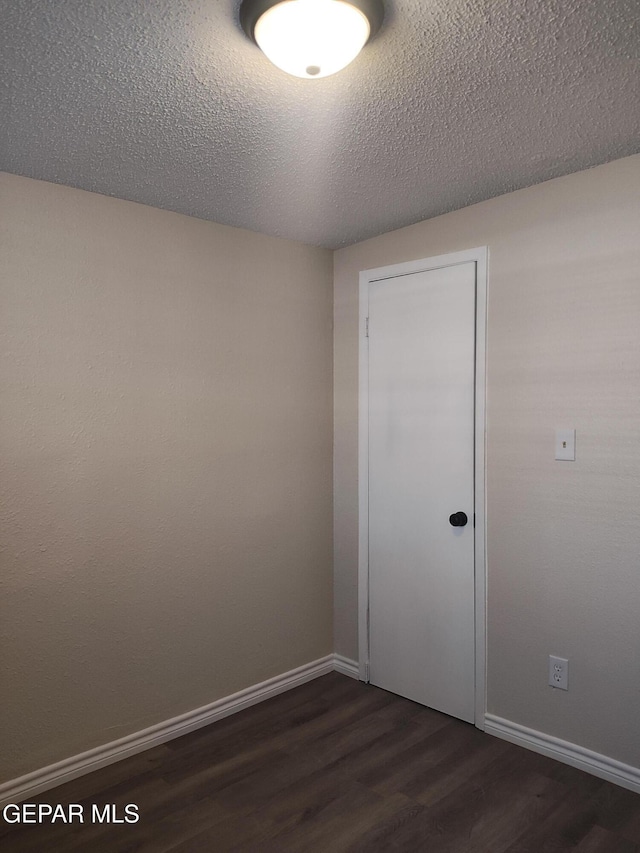338 Maricela Dr, El Paso, TX 79915 - spare room with dark wood-type flooring, baseboards, and a textured ceiling