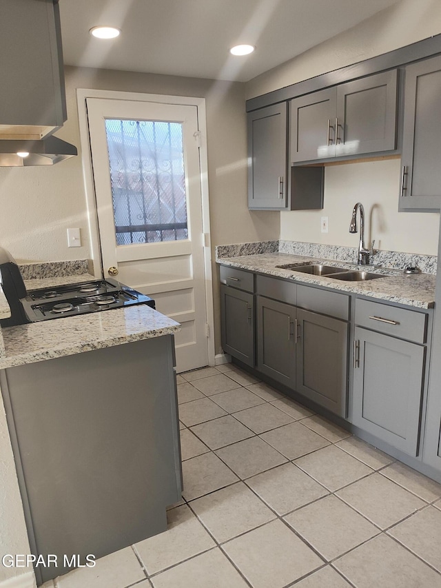 338 Maricela Dr, El Paso, TX 79915 - kitchen featuring a sink, gray cabinets, range, under cabinet range hood, and light tile patterned floors
