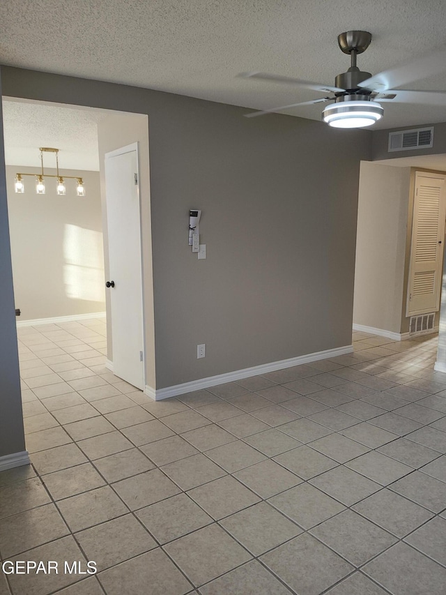 338 Maricela Dr, El Paso, TX 79915 - spare room with a textured ceiling, ceiling fan, light tile patterned flooring, and baseboards
