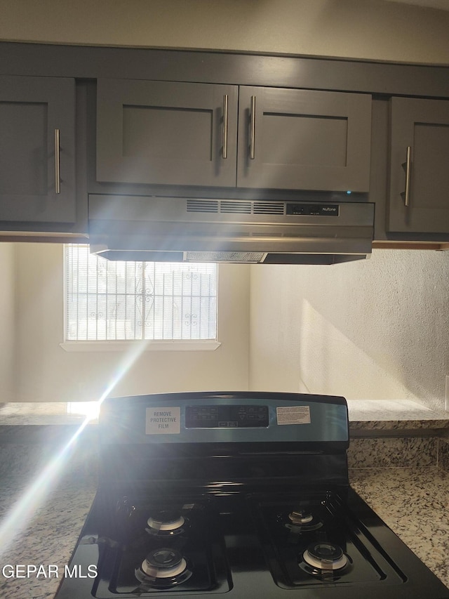 338 Maricela Dr, El Paso, TX 79915 - kitchen view of stainless steel range oven, under cabinet range hood, gray cabinetry, and light countertops