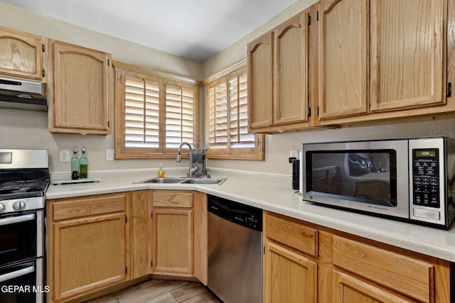 14025 Stoutland Ln, El Paso, TX 79928 - kitchen with stainless steel appliances, a sink, under cabinet range hood, and light countertops
