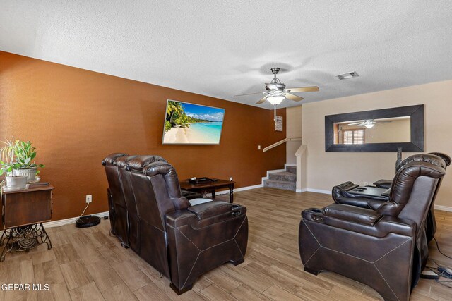 14025 Stoutland Ln, El Paso, TX 79928 - living room with stairway, light wood-type flooring, a ceiling fan, a textured ceiling, and baseboards