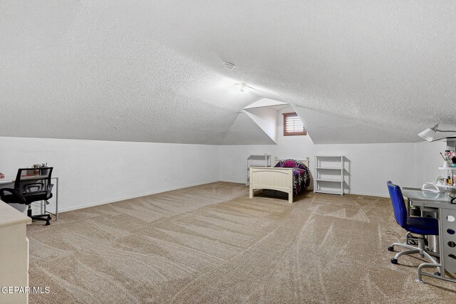 14025 Stoutland Ln, El Paso, TX 79928 - bedroom with a textured ceiling, carpet flooring, vaulted ceiling, baseboards, and an office area