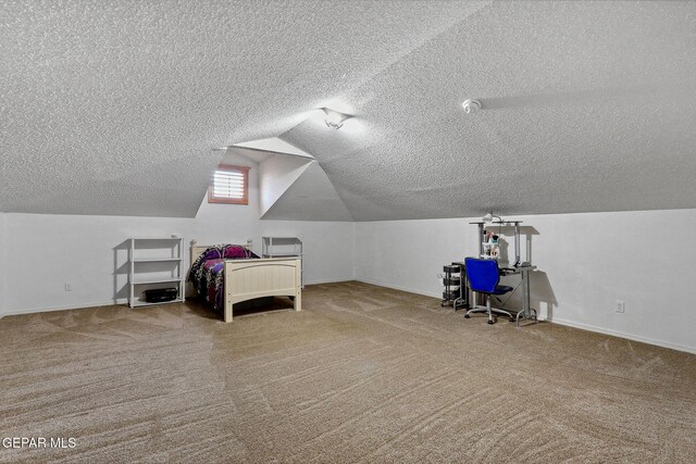 14025 Stoutland Ln, El Paso, TX 79928 - unfurnished bedroom featuring a textured ceiling, carpet, lofted ceiling, and baseboards