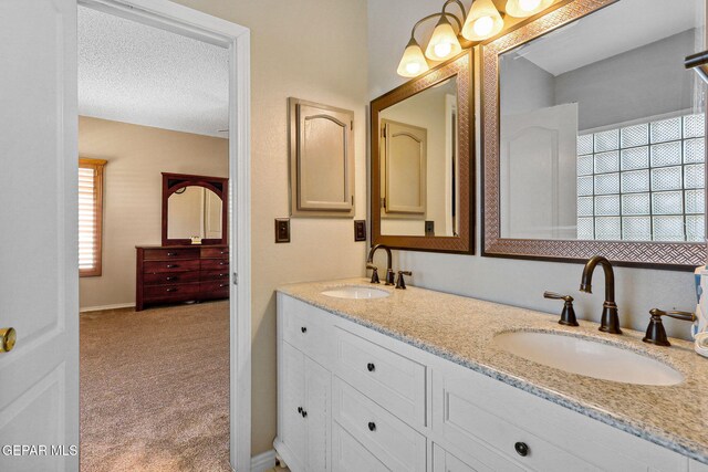14025 Stoutland Ln, El Paso, TX 79928 - full bath with double vanity and a textured ceiling
