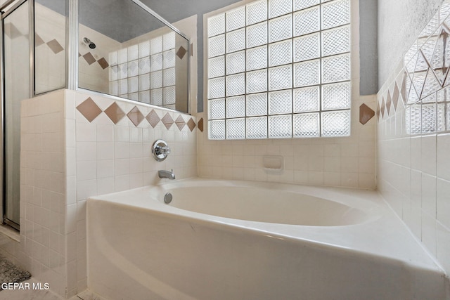 14025 Stoutland Ln, El Paso, TX 79928 - full bathroom featuring a garden tub, a shower stall, and tile walls