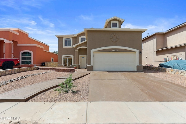 14025 Stoutland Ln, El Paso, TX 79928 - mediterranean / spanish-style home with stucco siding, driveway, and an attached garage