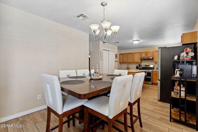 14025 Stoutland Ln, El Paso, TX 79928 - dining space with a chandelier, light wood-style flooring, and baseboards