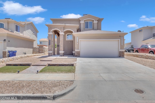 3112 Java Chip Pl, El Paso, TX 79938 - mediterranean / spanish house with stone siding, driveway, stucco siding, and an attached garage