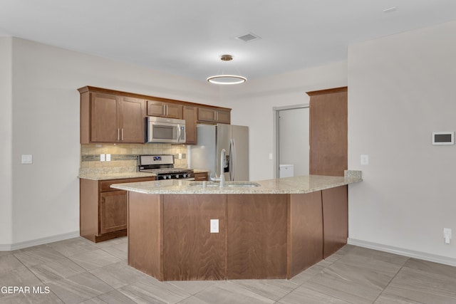 3112 Java Chip Pl, El Paso, TX 79938 - kitchen featuring stainless steel appliances, light stone countertops, backsplash, a peninsula, and a sink
