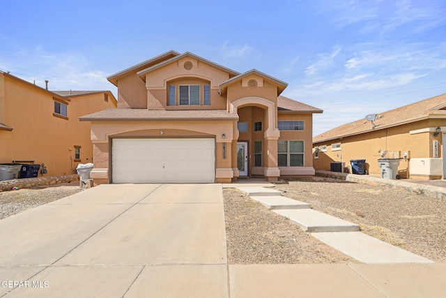 14309 Coyote Trl, El Paso, TX 79938 - mediterranean / spanish-style house with stucco siding, a garage, concrete driveway, and central AC unit
