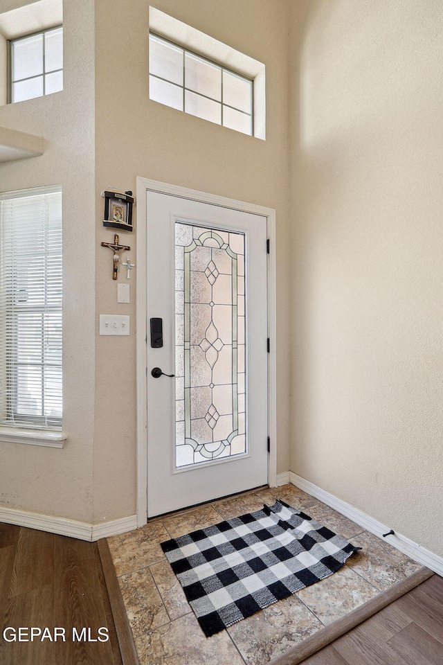 14309 Coyote Trl, El Paso, TX 79938 - entrance foyer with a towering ceiling, baseboards, plenty of natural light, and wood finished floors