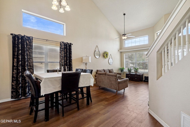 14309 Coyote Trl, El Paso, TX 79938 - dining room with high vaulted ceiling, wood finished floors, a ceiling fan, a chandelier, and baseboards