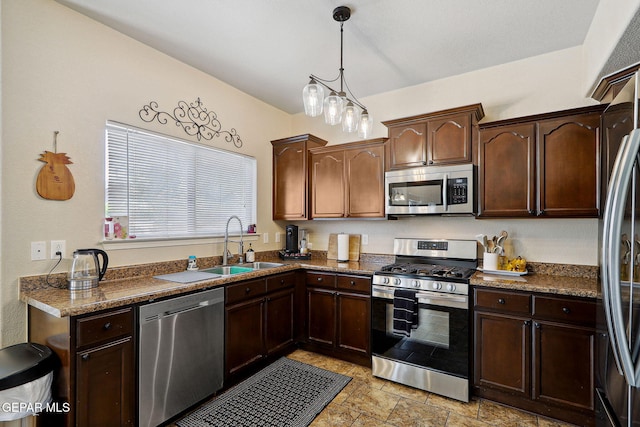 14309 Coyote Trl, El Paso, TX 79938 - kitchen featuring stainless steel appliances, a sink, decorative light fixtures, and dark brown cabinetry