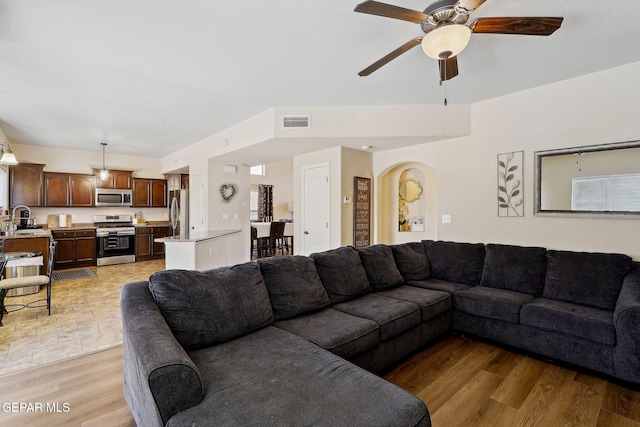 14309 Coyote Trl, El Paso, TX 79938 - living room featuring ceiling fan, light wood-style floors, and arched walkways