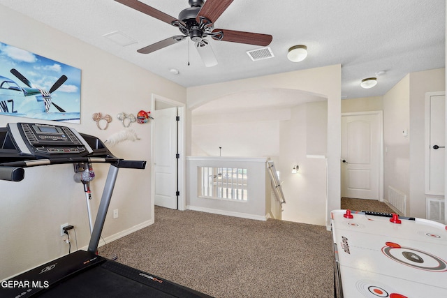 14309 Coyote Trl, El Paso, TX 79938 - workout area featuring arched walkways, carpet floors, ceiling fan, and baseboards