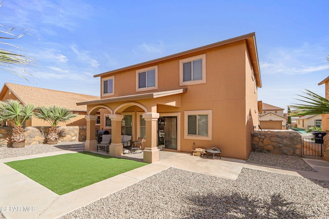 14309 Coyote Trl, El Paso, TX 79938 - back of house with stucco siding, a gate, and a patio