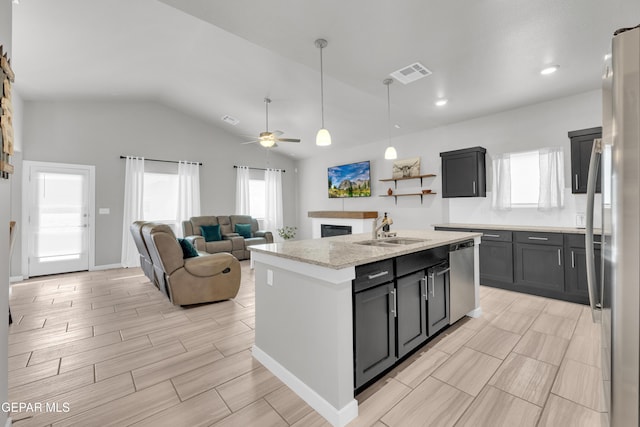 13688 Lago Vista Ave, El Paso, TX 79928 - kitchen featuring a sink, stainless steel appliances, a ceiling fan, a kitchen island with sink, and decorative light fixtures