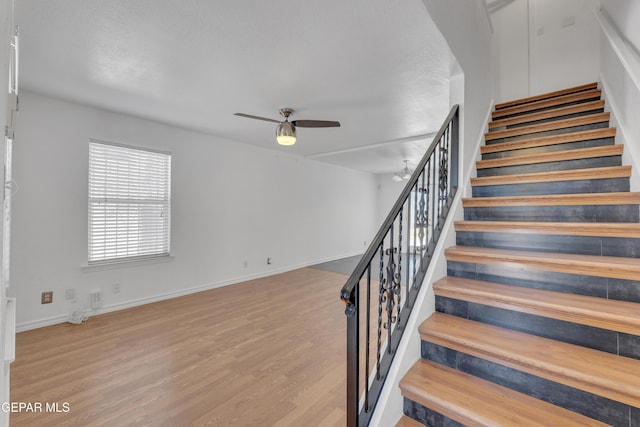 5424 Fire Ridge Cir, El Paso, TX 79932 - stairs featuring ceiling fan, wood finished floors, and baseboards