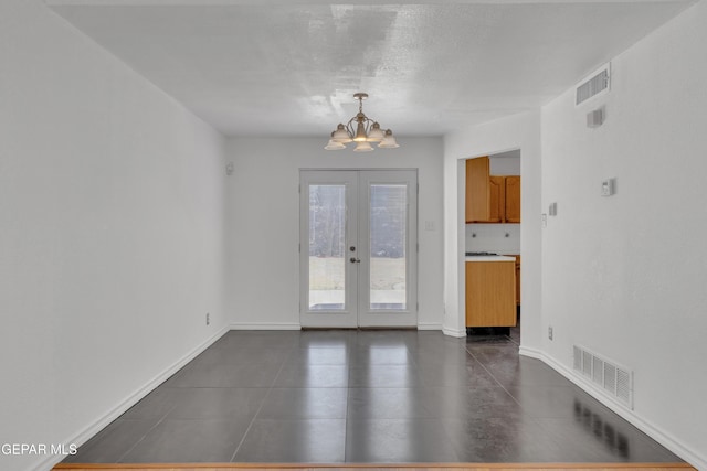 5424 Fire Ridge Cir, El Paso, TX 79932 - unfurnished room with a chandelier, dark tile patterned floors, french doors, baseboards, and a textured ceiling