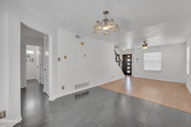 5424 Fire Ridge Cir, El Paso, TX 79932 - unfurnished living room featuring tile patterned floors, stairs, a chandelier, a ceiling fan, and baseboards
