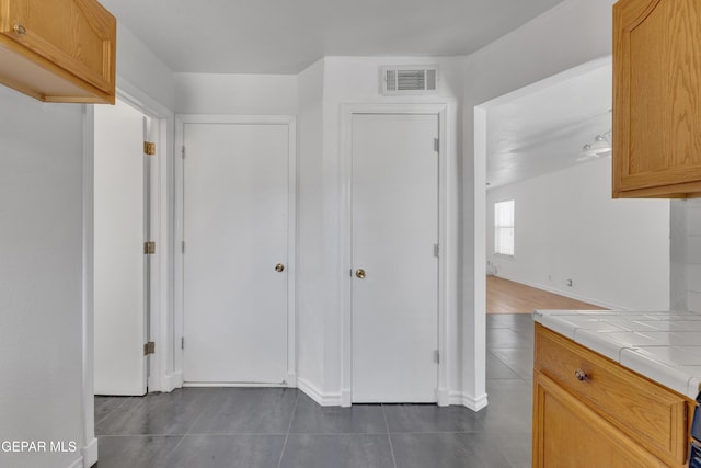 5424 Fire Ridge Cir, El Paso, TX 79932 - kitchen with tile countertops, dark tile patterned floors, and baseboards