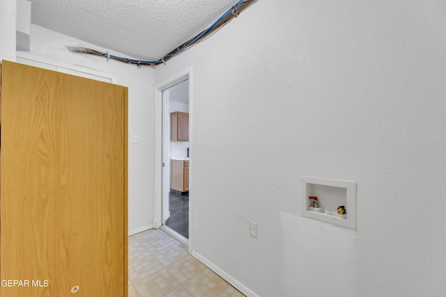 5424 Fire Ridge Cir, El Paso, TX 79932 - washroom featuring hookup for a washing machine, a textured ceiling, baseboards, and light floors