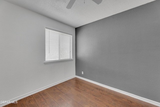 5424 Fire Ridge Cir, El Paso, TX 79932 - spare room with baseboards, ceiling fan, dark wood-style flooring, and a textured ceiling