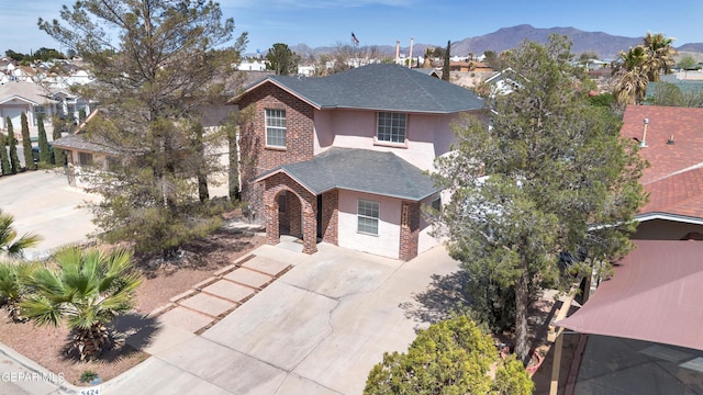 5424 Fire Ridge Cir, El Paso, TX 79932 - traditional-style home featuring driveway, roof with shingles, a mountain view, stucco siding, and brick siding