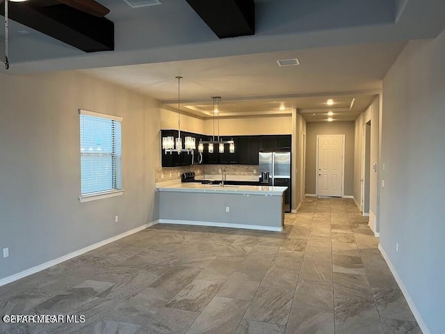 14772 John Mcneely Ave, El Paso, TX 79938 - kitchen featuring stainless steel fridge with ice dispenser, dark cabinetry, light countertops, tasteful backsplash, and a peninsula