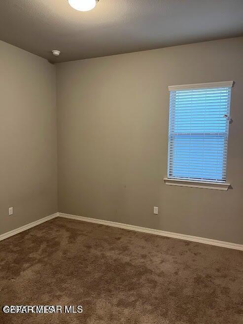 14772 John Mcneely Ave, El Paso, TX 79938 - unfurnished room with dark colored carpet and baseboards