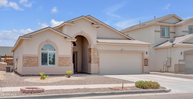 12776 Runway Ave, El Paso, TX 79928 - view of front facade featuring an attached garage, stucco siding, concrete driveway, cooling unit, and stone siding