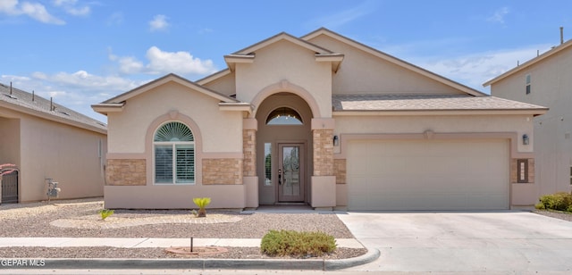 12776 Runway Ave, El Paso, TX 79928 - mediterranean / spanish house featuring stucco siding, stone siding, an attached garage, and driveway