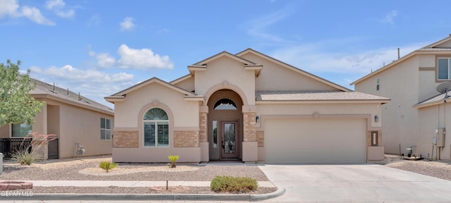 12776 Runway Ave, El Paso, TX 79928 - mediterranean / spanish-style home featuring an attached garage, concrete driveway, stucco siding, and stone siding
