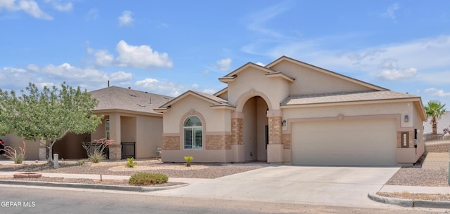 12776 Runway Ave, El Paso, TX 79928 - mediterranean / spanish-style house with an attached garage, stucco siding, and driveway
