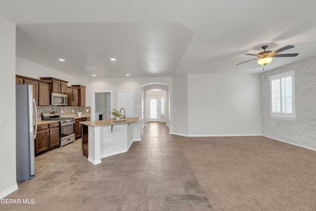 12776 Runway Ave, El Paso, TX 79928 - kitchen featuring appliances with stainless steel finishes, arched walkways, a sink, ceiling fan, and plenty of natural light
