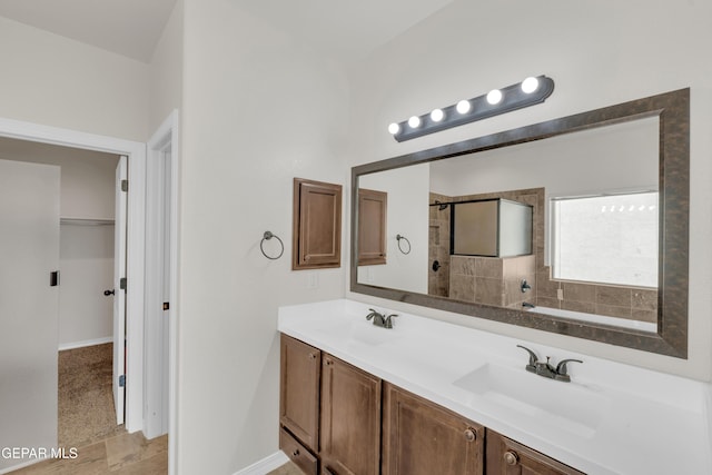 12776 Runway Ave, El Paso, TX 79928 - bathroom with double vanity, baseboards, and tiled shower