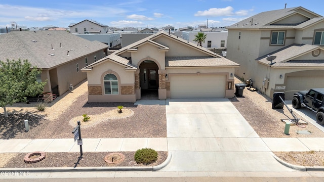 12776 Runway Ave, El Paso, TX 79928 - view of front facade with stucco siding, a garage, concrete driveway, stone siding, and a residential view