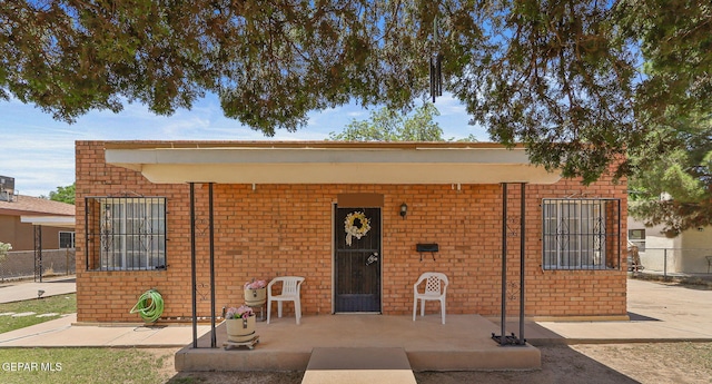 211 Green Haven Pl, El Paso, TX 79907 - view of front of house with brick siding and a porch
