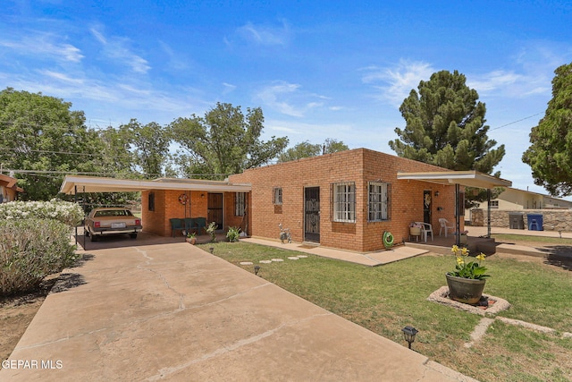 211 Green Haven Pl, El Paso, TX 79907 - view of front facade featuring brick siding, a front lawn, a carport, and concrete driveway