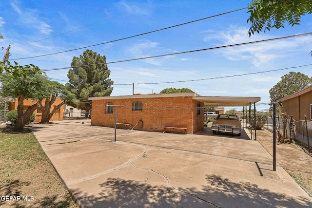 211 Green Haven Pl, El Paso, TX 79907 - rear view of house featuring an attached carport, concrete driveway, and brick siding