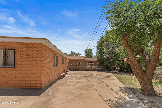 211 Green Haven Pl, El Paso, TX 79907 - view of side of property with brick siding and a patio area